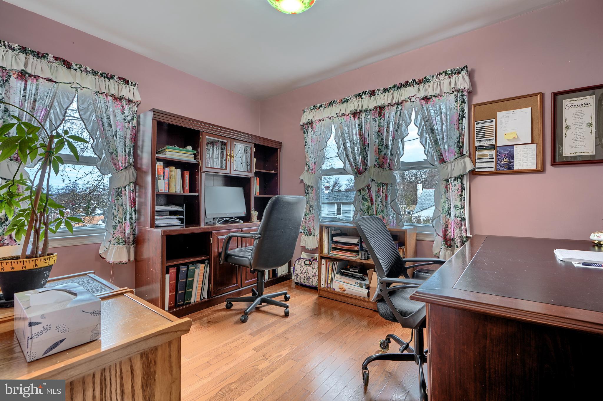 297 Hazel Avenue Baltimore, MD 21227 - Photo 18 of 56 a view of a workspace with furniture and a bookshelf