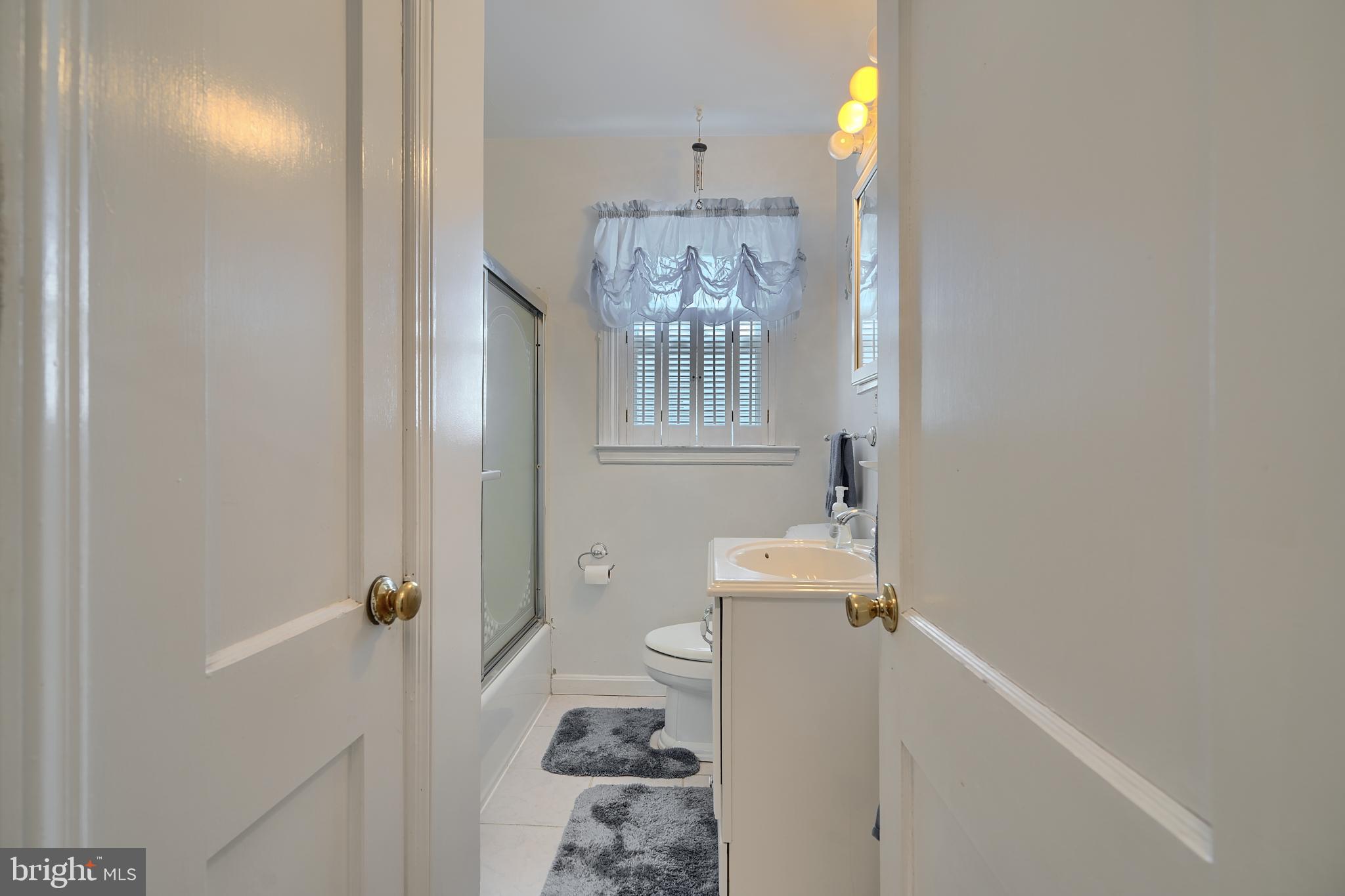 297 Hazel Avenue Baltimore, MD 21227 - Photo 20 of 56 a bathroom with a sink toilet and shower