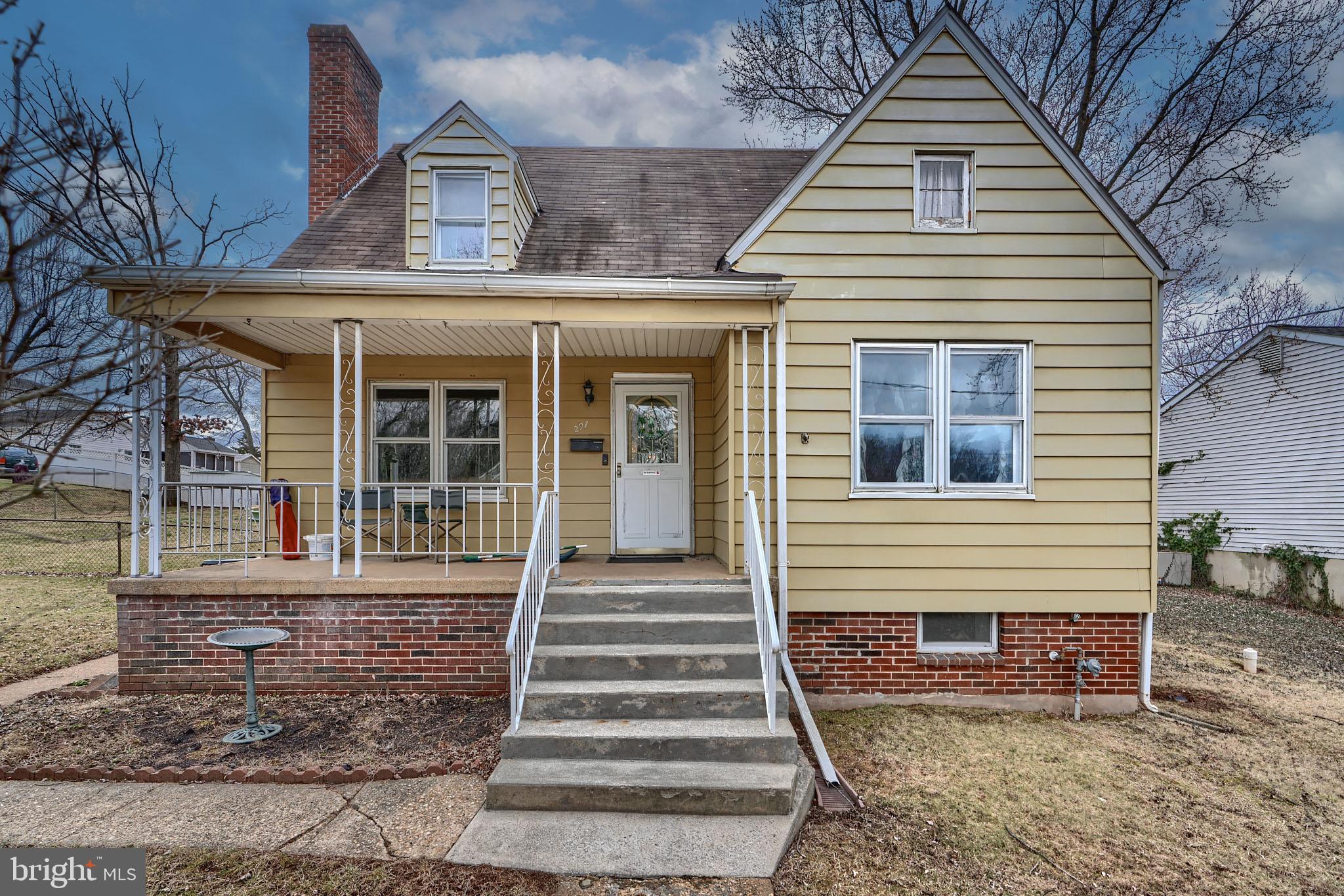 297 Hazel Avenue Baltimore, MD 21227 - Photo 2 of 56 a front view of a house with a porch