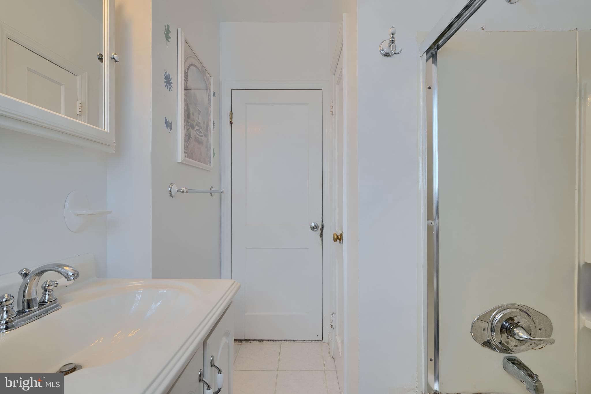 297 Hazel Avenue Baltimore, MD 21227 - Photo 23 of 56 a bathroom with a sink and a mirror