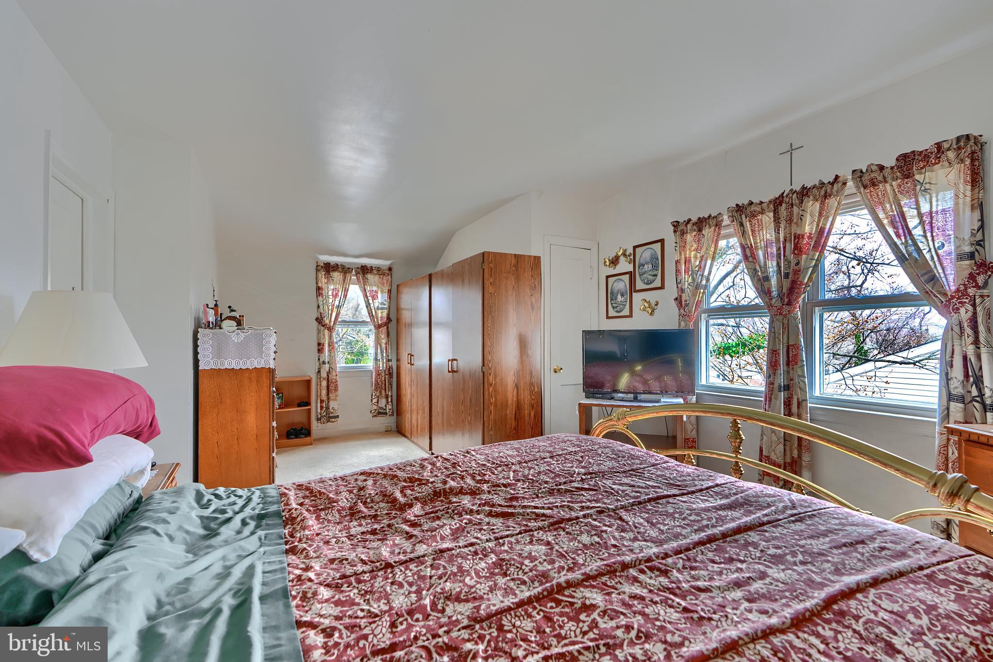 297 Hazel Avenue Baltimore, MD 21227 - Photo 25 of 56 a bedroom with a large bed and a large window