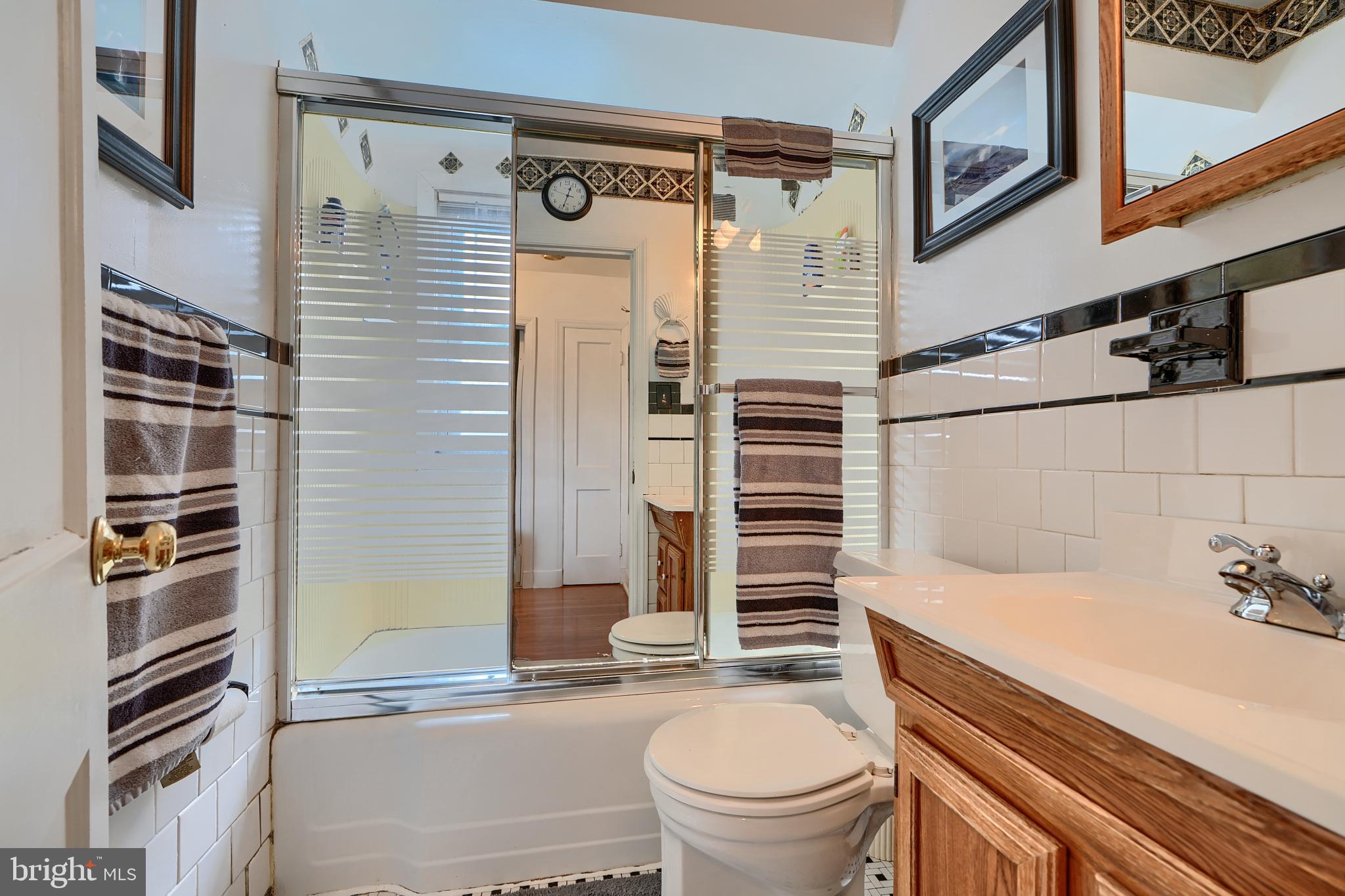 297 Hazel Avenue Baltimore, MD 21227 - Photo 33 of 56 a bathroom with a sink a toilet and shower