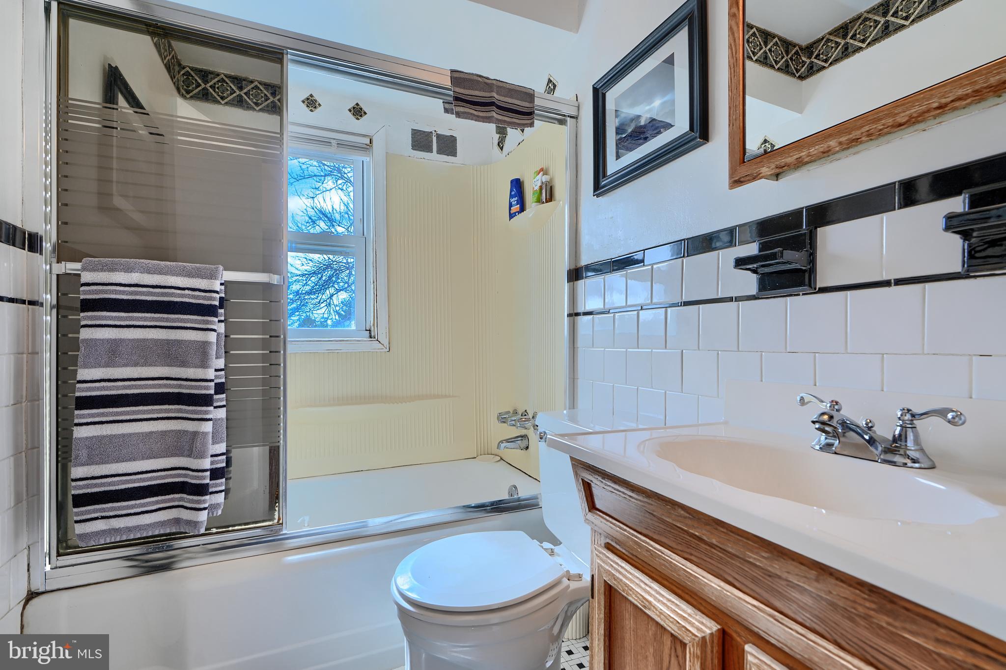 297 Hazel Avenue Baltimore, MD 21227 - Photo 35 of 56 a bathroom with a sink toilet and shower