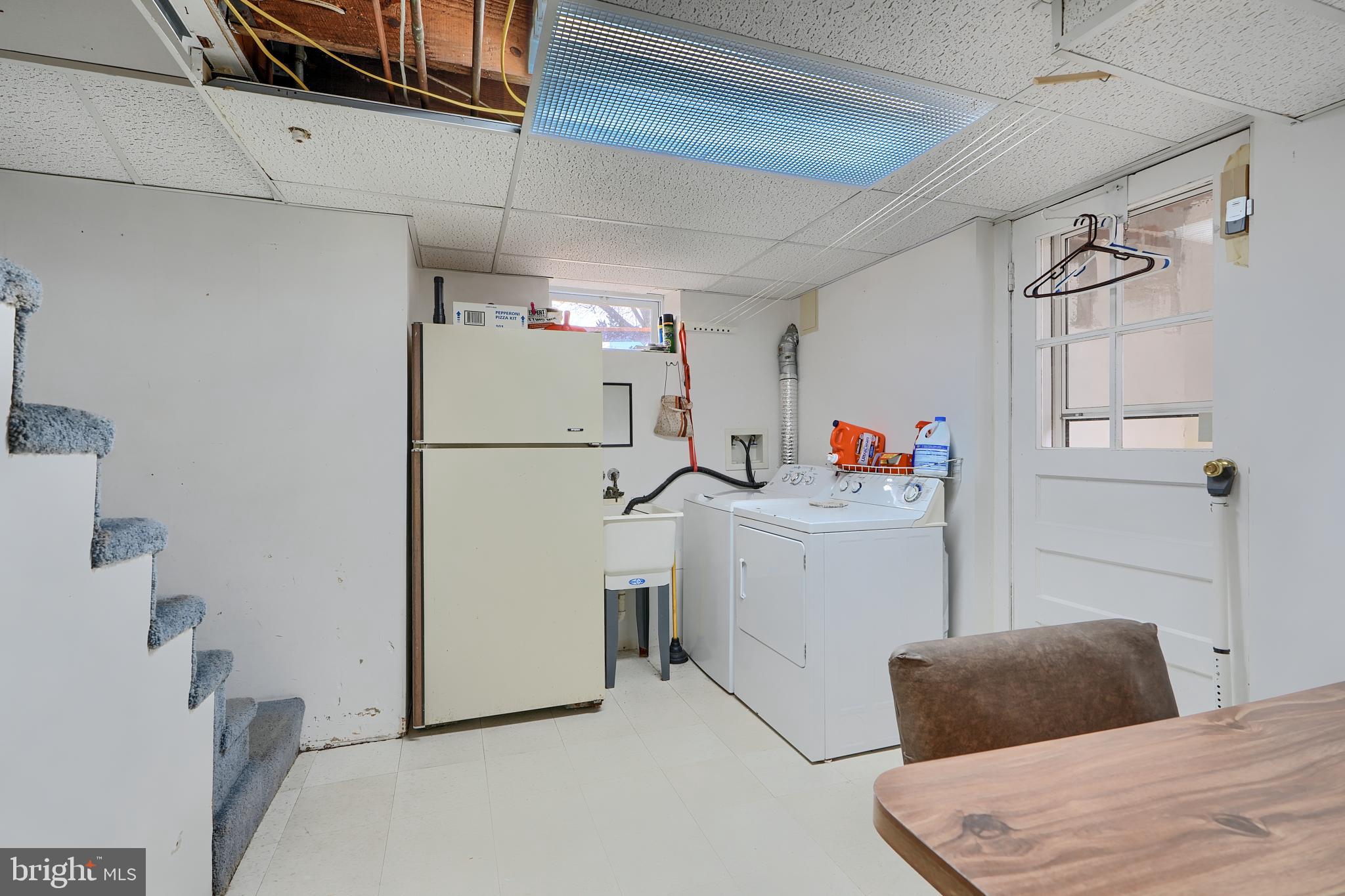 297 Hazel Avenue Baltimore, MD 21227 - Photo 46 of 56 a bedroom with a bed and a refrigerator