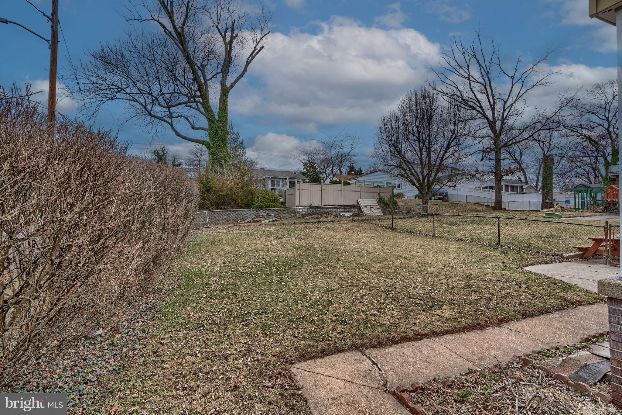 297 Hazel Avenue Baltimore, MD 21227 - Photo 48 of 56 a view of a yard with a tree