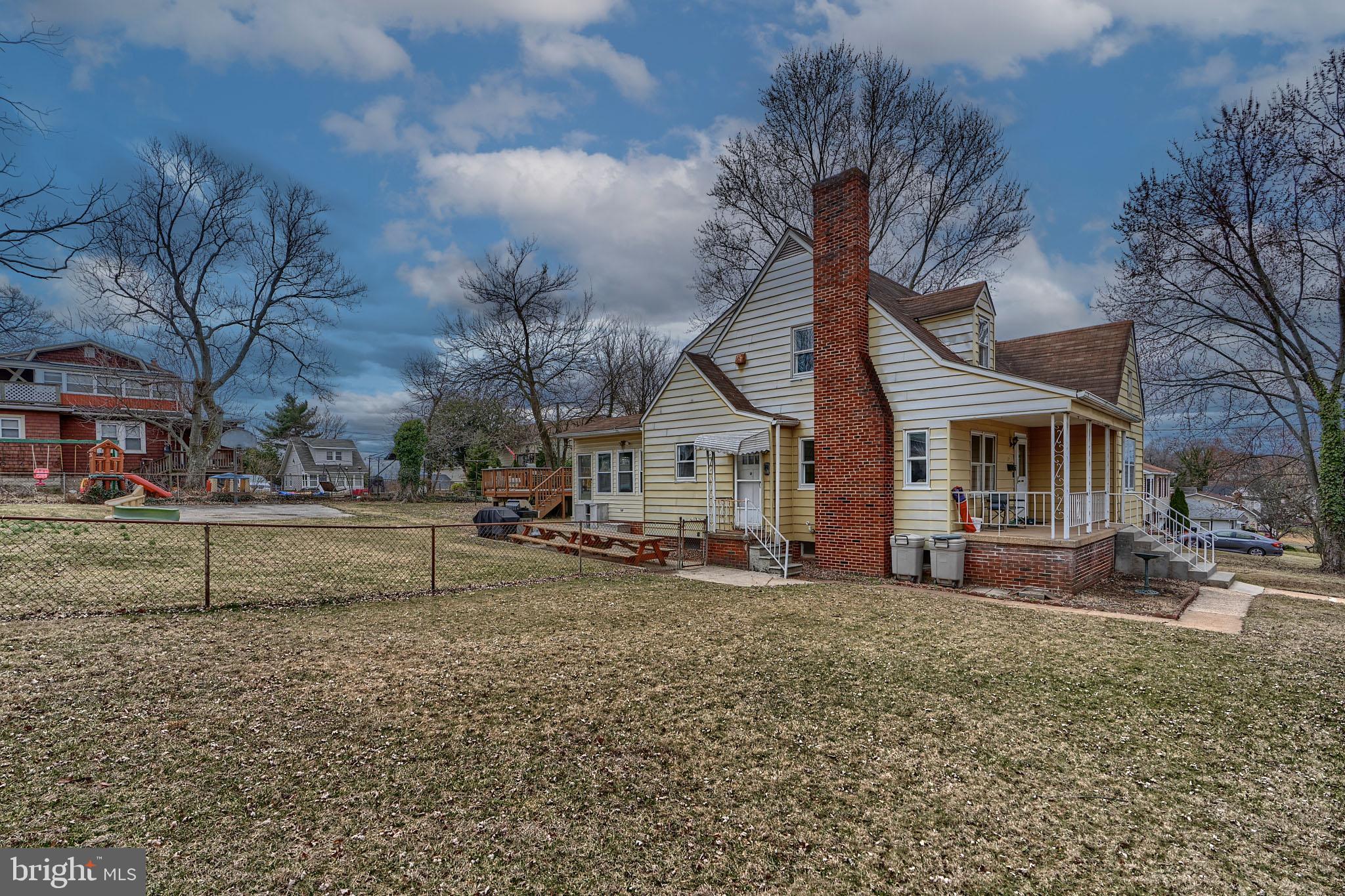 297 Hazel Avenue Baltimore, MD 21227 - Photo 49 of 56 a view of a house with a yard and sitting area