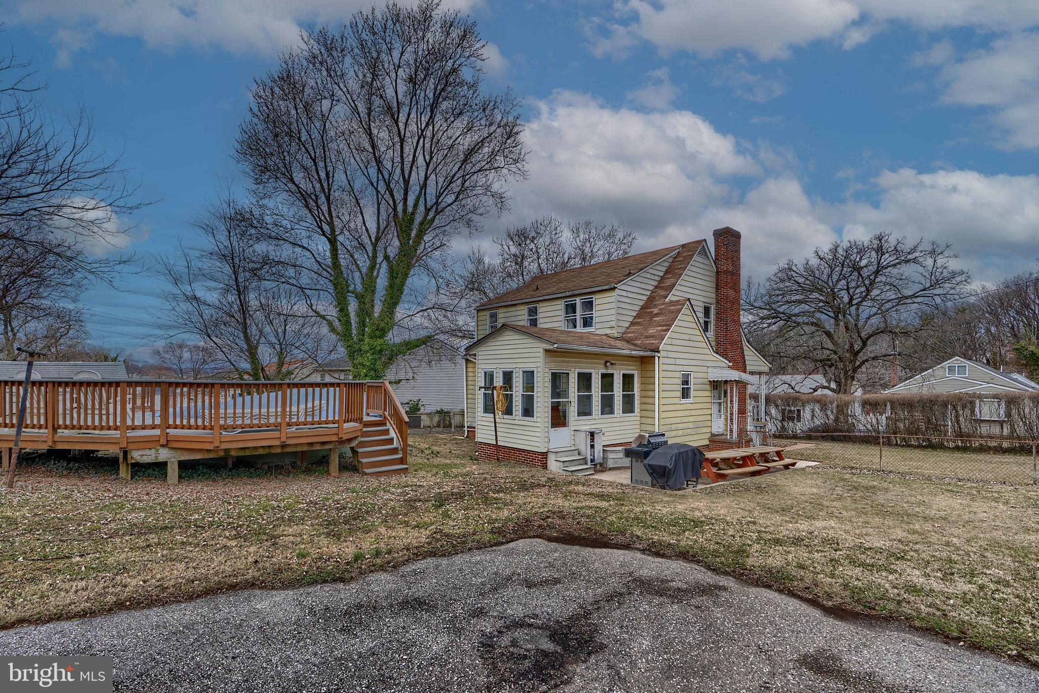 297 Hazel Avenue Baltimore, MD 21227 - Photo 52 of 56 a view of a house with a yard and sitting area