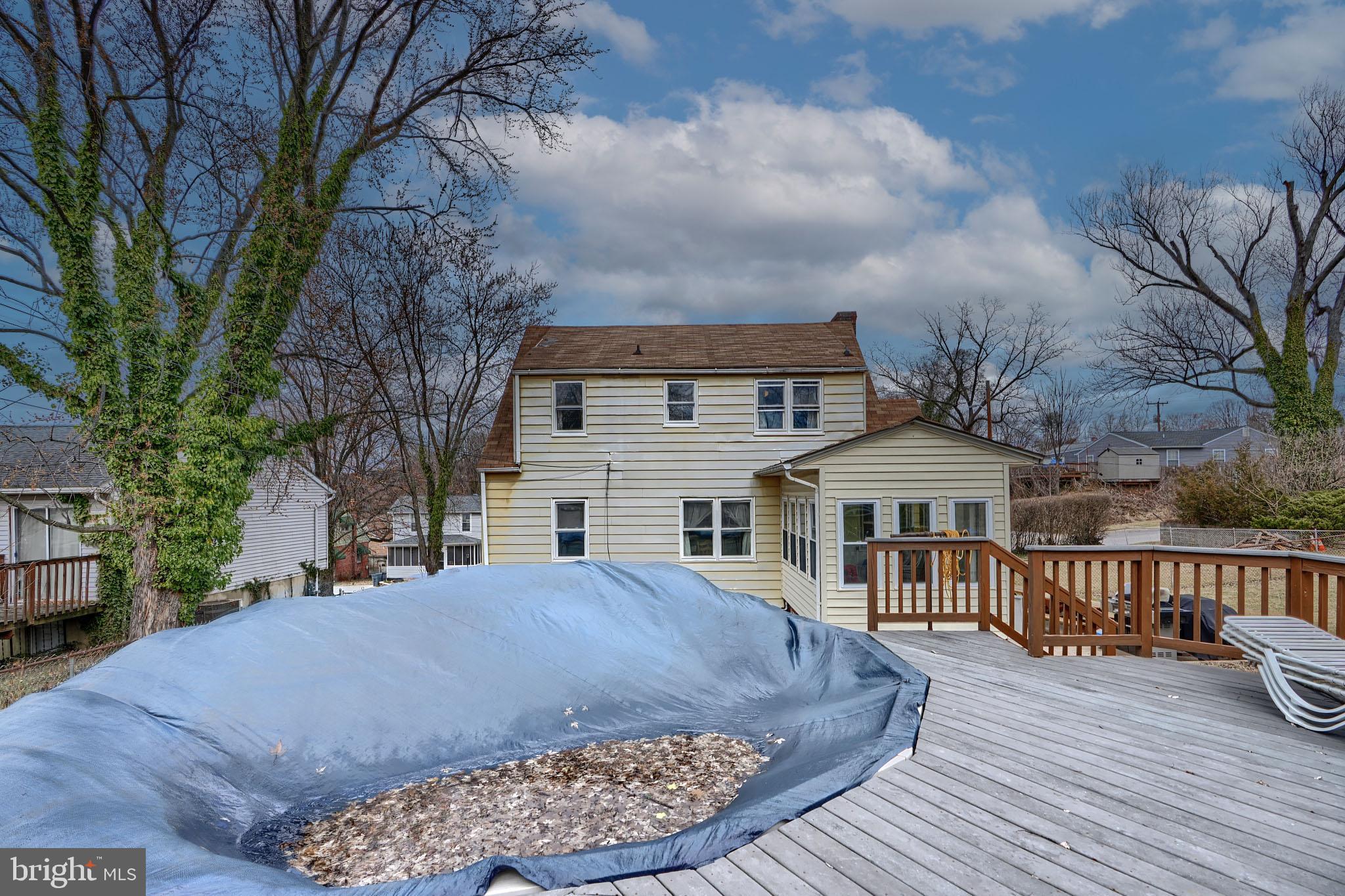 297 Hazel Avenue Baltimore, MD 21227 - Photo 55 of 56 a view of house with yard outdoor seating and covered with snow in the background