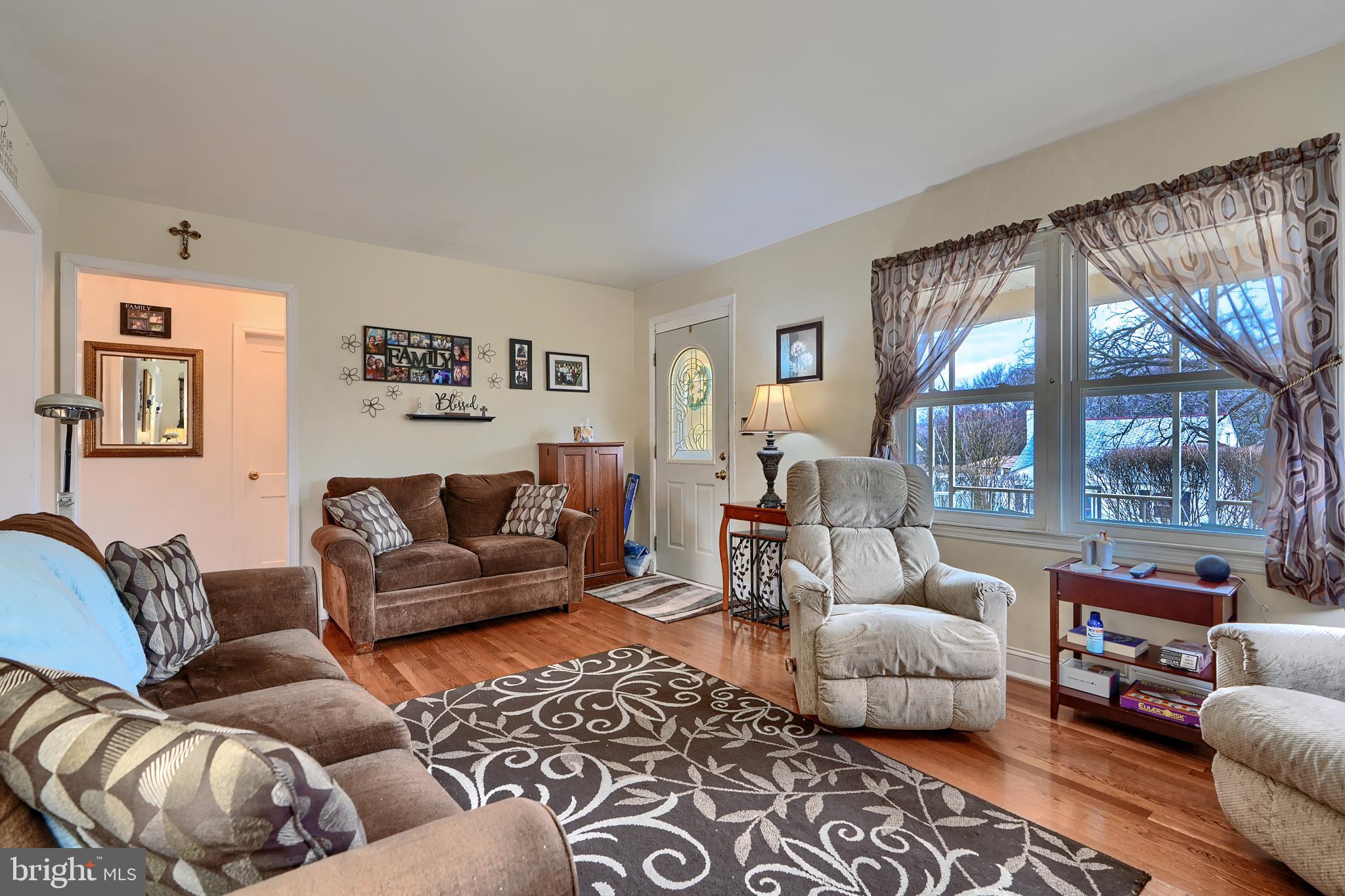 297 Hazel Avenue Baltimore, MD 21227 - Photo 6 of 56 a living room with furniture and a large window