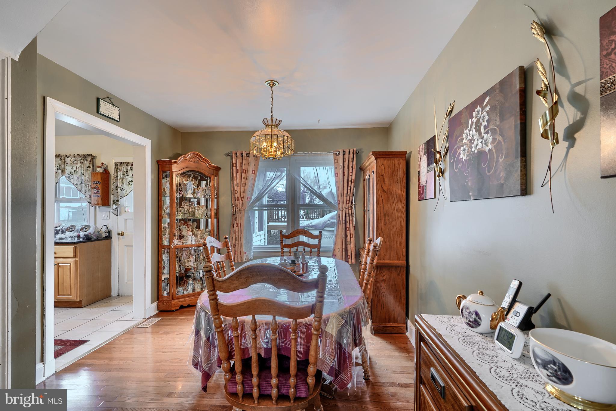 297 Hazel Avenue Baltimore, MD 21227 - Photo 8 of 56 a view of a dining room with furniture window and wooden floor