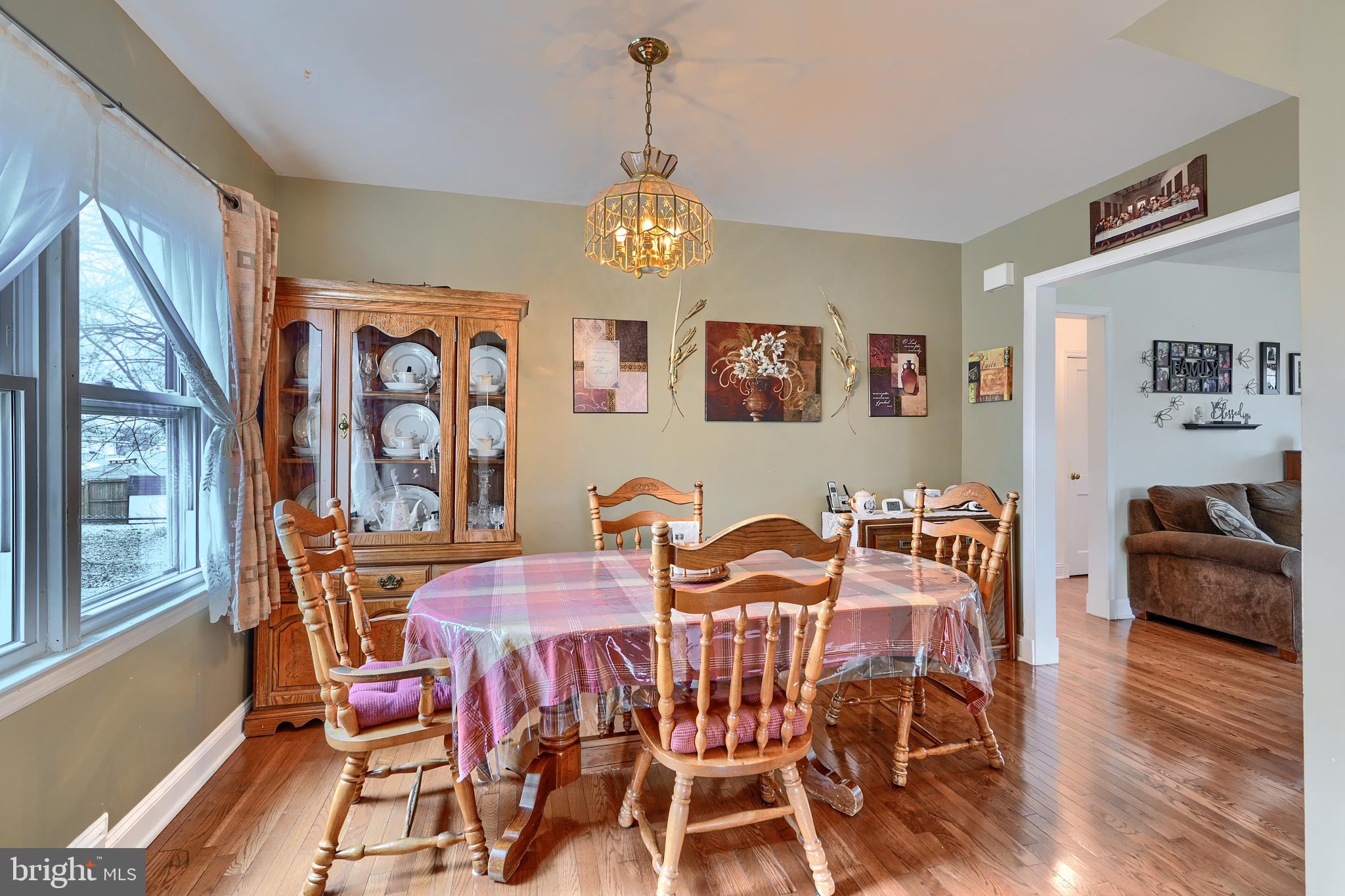 297 Hazel Avenue Baltimore, MD 21227 - Photo 9 of 56 a view of a dining room with furniture wooden floor and a chandelier