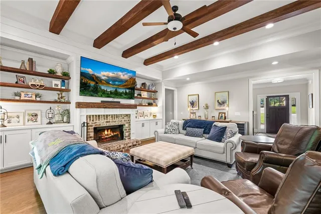 a living room with fireplace furniture and a flat screen tv