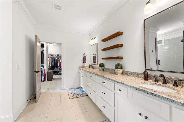 a large bathroom with a granite countertop double vanity sink a mirror and a