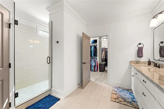 a view of walk in closet with clothes