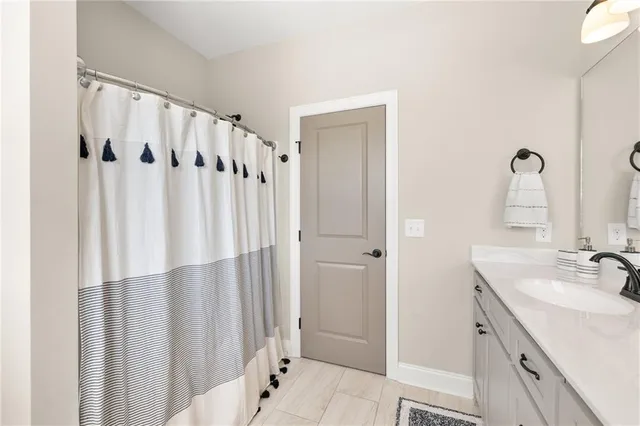a bedroom with bed and wooden floor