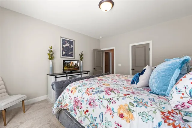 a front view of a house with a yard and trees