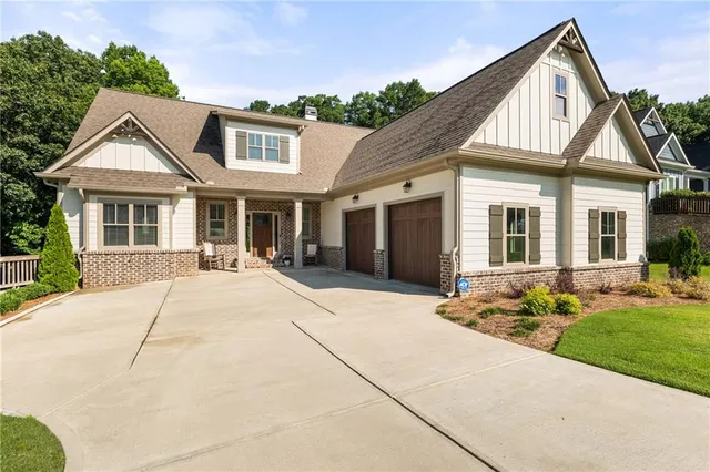 an aerial view of residential houses with outdoor space and trees