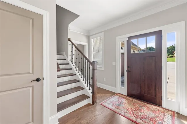 a view of a hallway with wooden floor and entryway