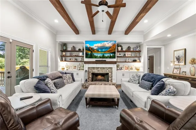 a living room with furniture a fireplace and a flat screen tv