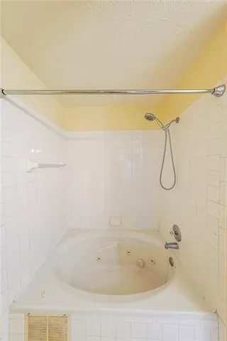 a bathroom with a bath tub and shower