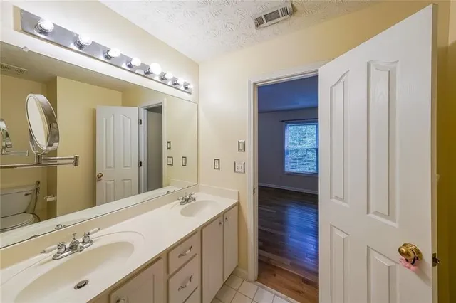 a bathroom with a double vanity sink and a mirror