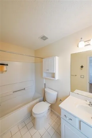 a bathroom with a toilet a sink and bathtub