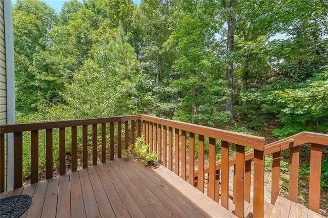 a balcony with wooden floor and fence