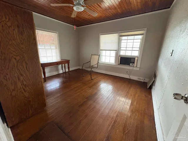 wooden floor in an empty room with a window