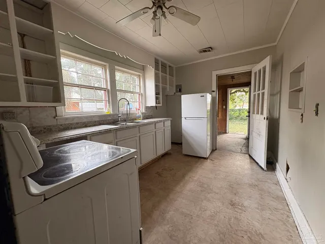a kitchen with refrigerator and window