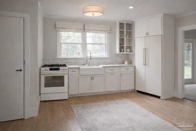 a kitchen with white cabinets and white appliances
