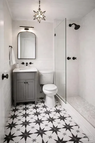a bathroom with a toilet sink and mirror