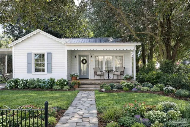 a front view of a house with a garden
