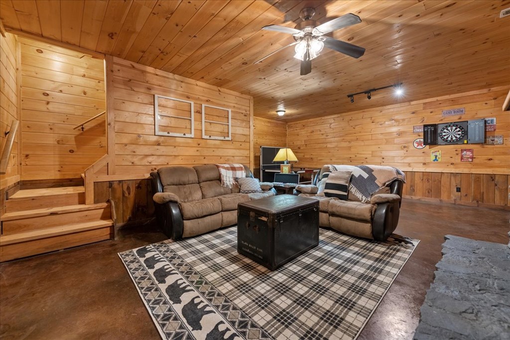 126 Brookwood Drive Blue Ridge, GA 30513 - Photo 76 of 106 a living room with furniture and a chandelier