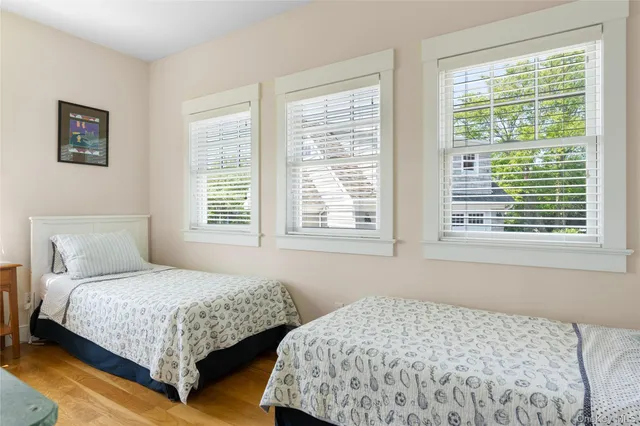 a bedroom with two beds and a window