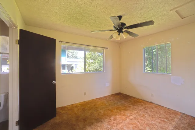 a view of a livingroom with a window and a ceiling fan