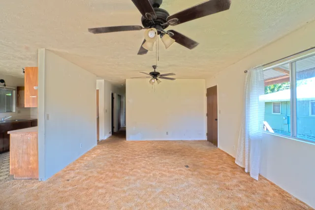 a view of a livingroom with a ceiling fan and a window