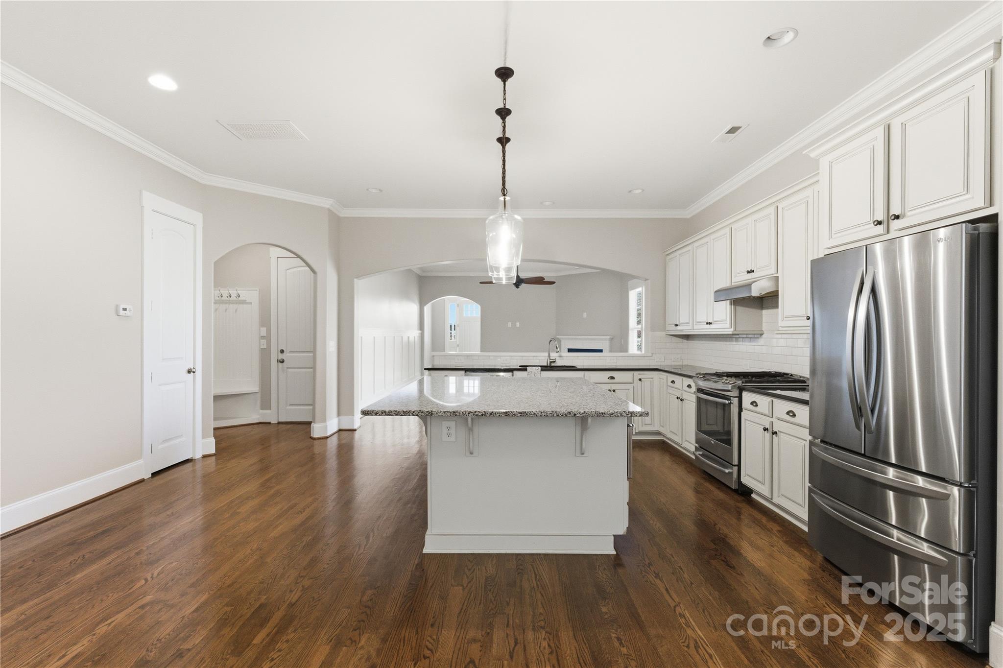 743 Bluff Loop Road Rock Hill, SC 29730 - Photo 11 of 37 a kitchen with stainless steel appliances granite countertop a refrigerator a sink dishwasher a stove and white countertops with wooden floor