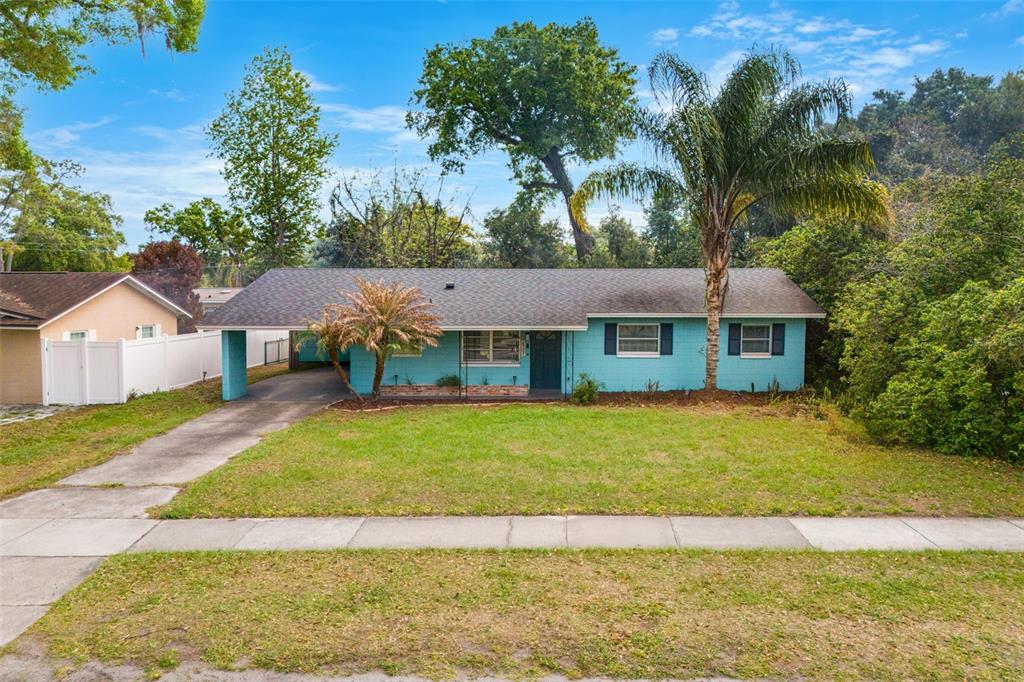 a front view of a house with a garden and yard