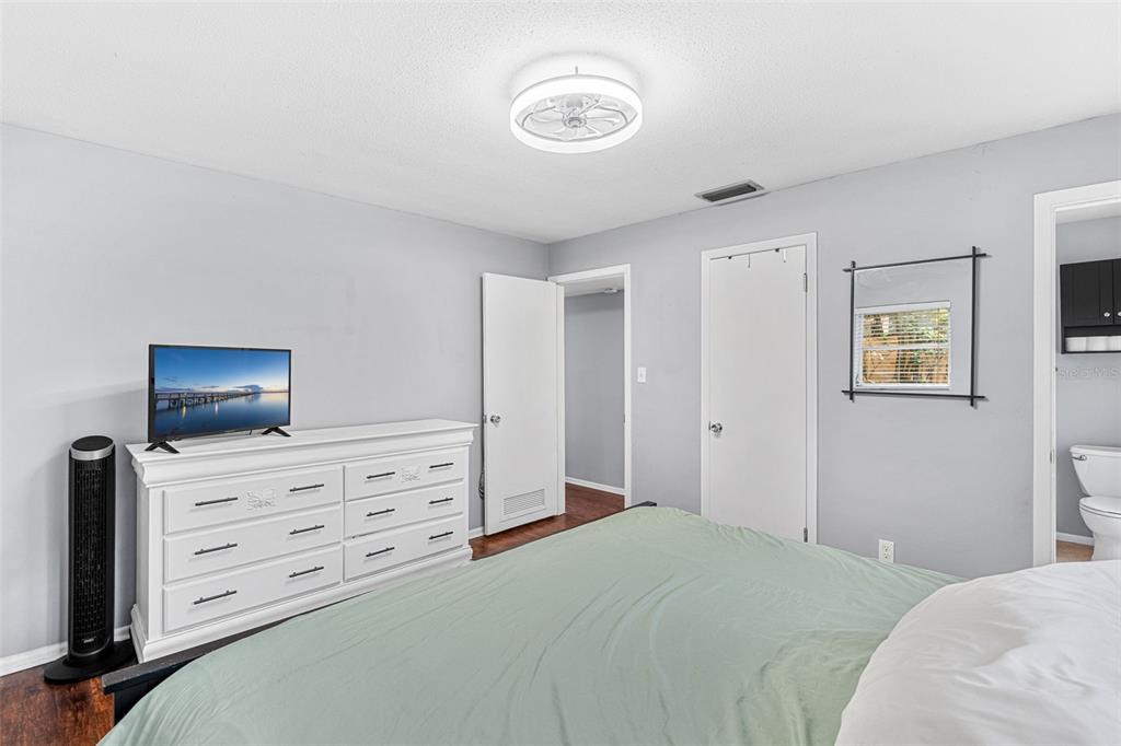 2923 Conway Gardens Road Orlando, FL 32806 - Photo 13 of 28 a bedroom with a bed and furniture