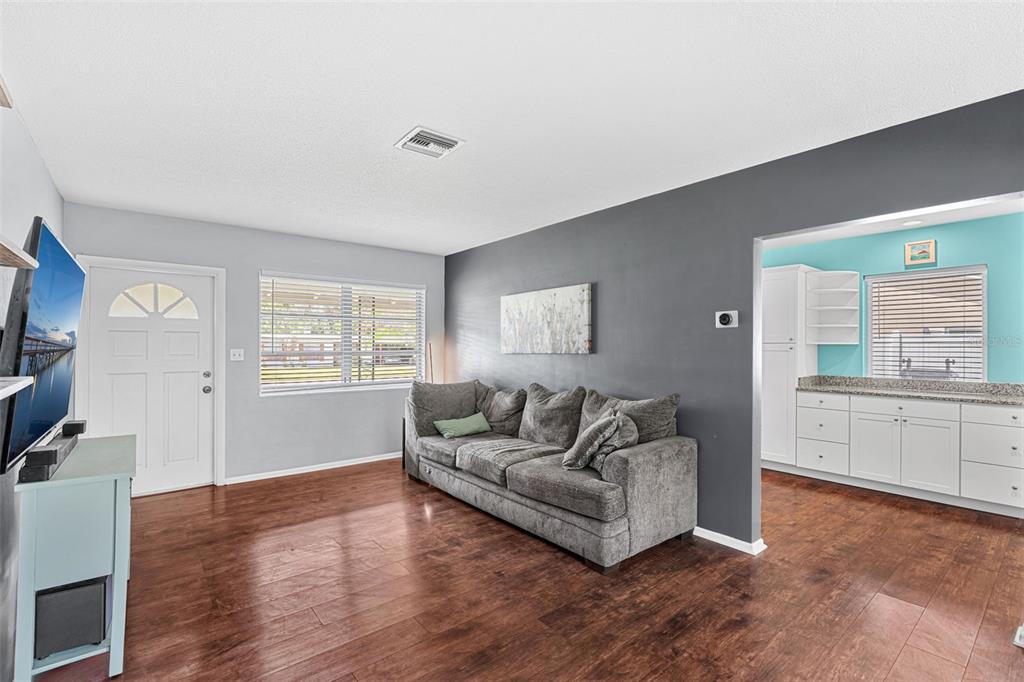 2923 Conway Gardens Road Orlando, FL 32806 - Photo 18 of 28 a living room with furniture and a flat screen tv