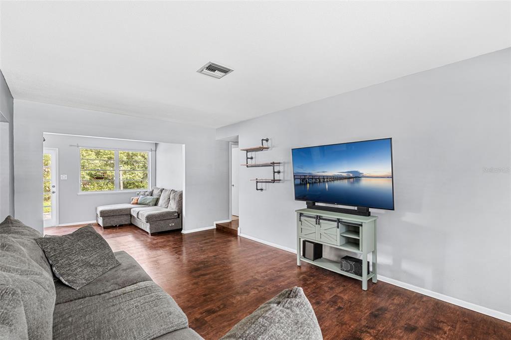 2923 Conway Gardens Road Orlando, FL 32806 - Photo 19 of 28 a living room with furniture and a flat screen tv