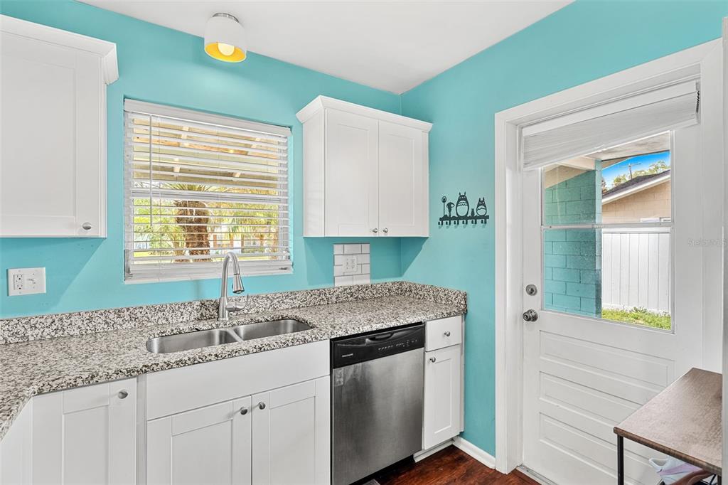 2923 Conway Gardens Road Orlando, FL 32806 - Photo 22 of 28 a kitchen with granite countertop a sink and a window