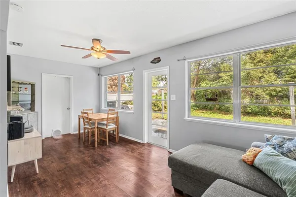 a living room with furniture and wooden floor