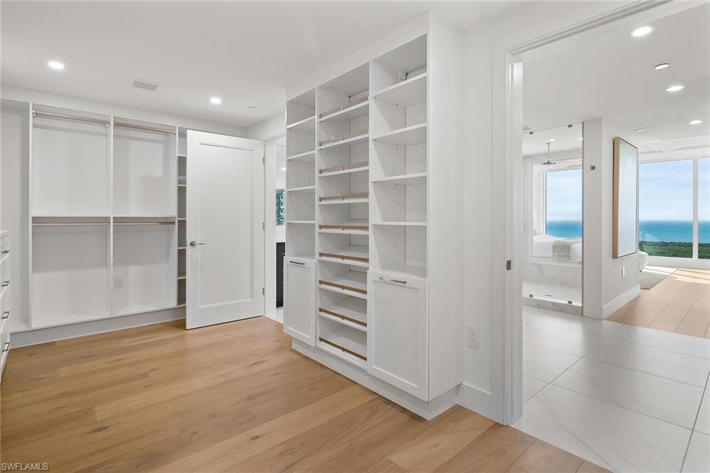 13935 Old Coast Road, Unit 2206 Naples, FL 34110 - Photo 12 of 50 Generous custom built-in primary closet filled with natural light and open to spectacular water views