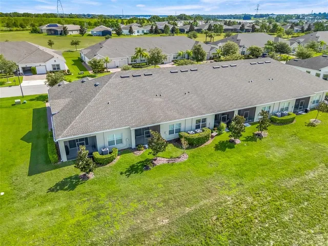 an aerial view of a house with garden space and lake view
