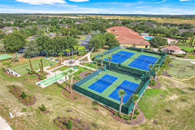 a view of a tennis ground with a large screen