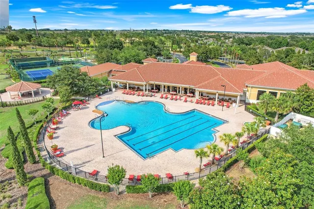 an aerial view of house with yard swimming pool and outdoor seating