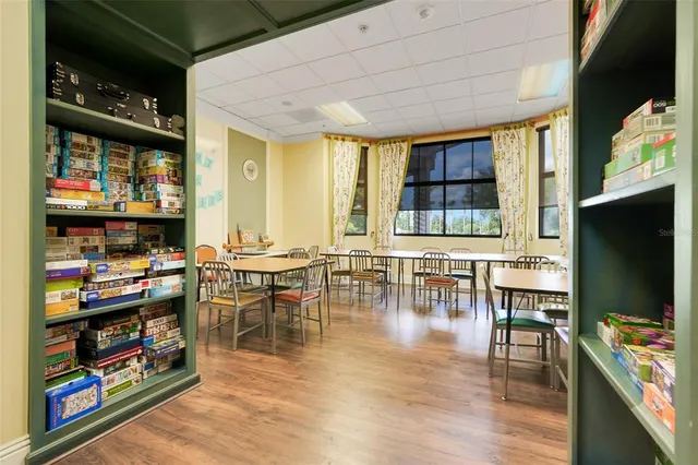 a dining room with lots of furniture and a flat screen tv