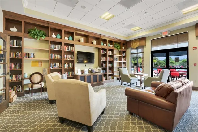 a living room with furniture and a book shelf