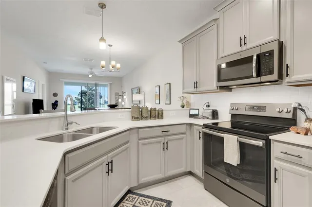 a kitchen with white cabinets stainless steel appliances and sink